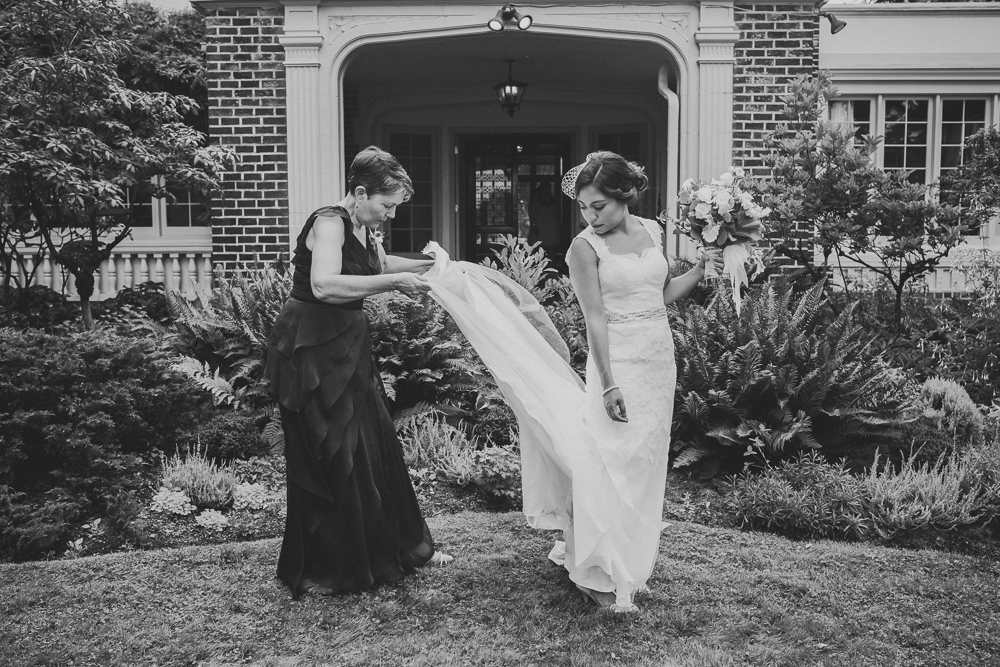 Keitlyn's weeding day. Photo Hollin Brodeur
Keitlyn's mom is arranging her wedding dress while Keitlyn holds her buquet and looks what her mom is doing. This photo is black and wwhite.